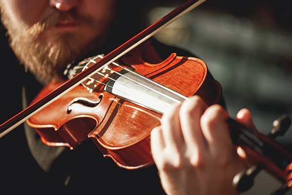 man playing the fiddle or violin